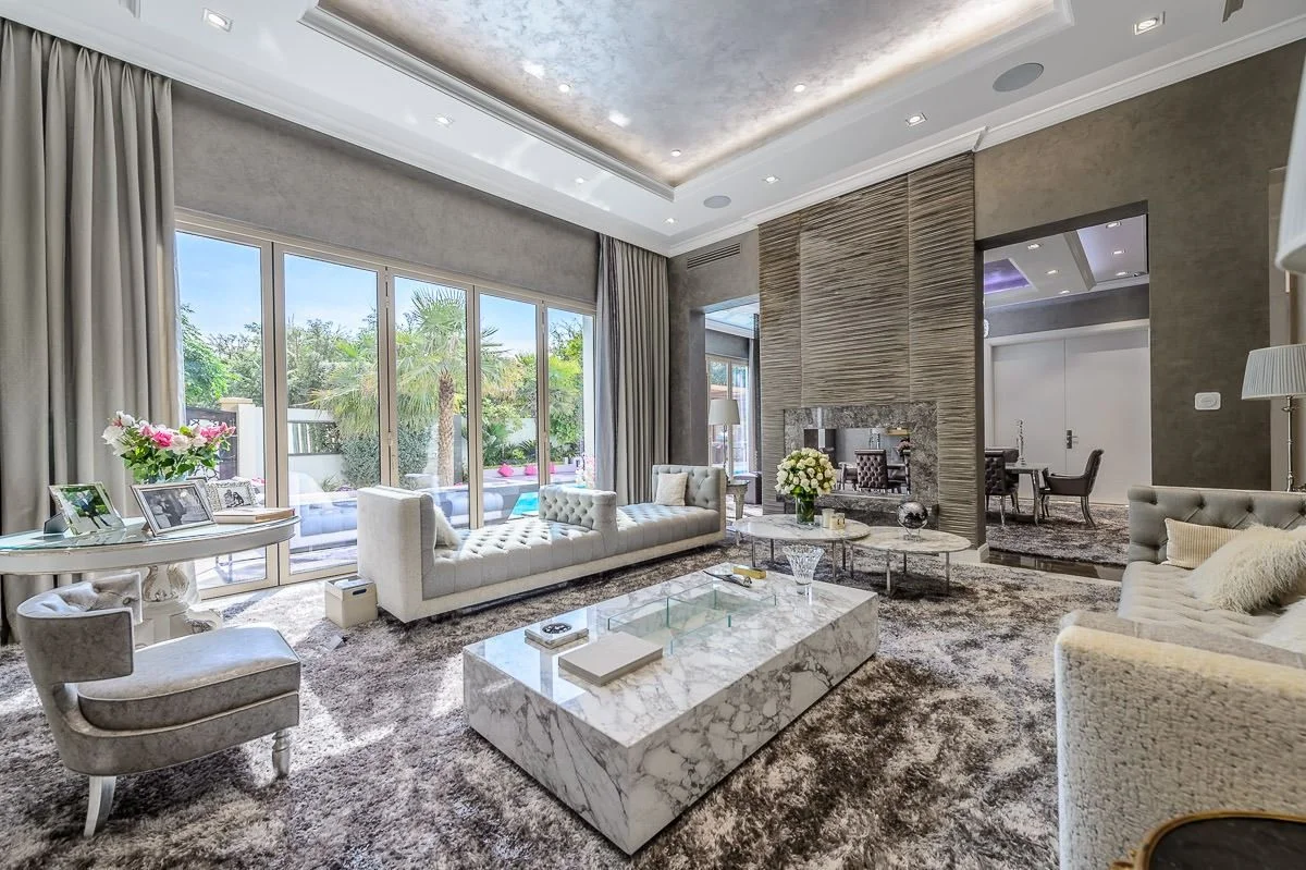Al Barsha villa: Double-height living room with a feature wall and coffered ceiling