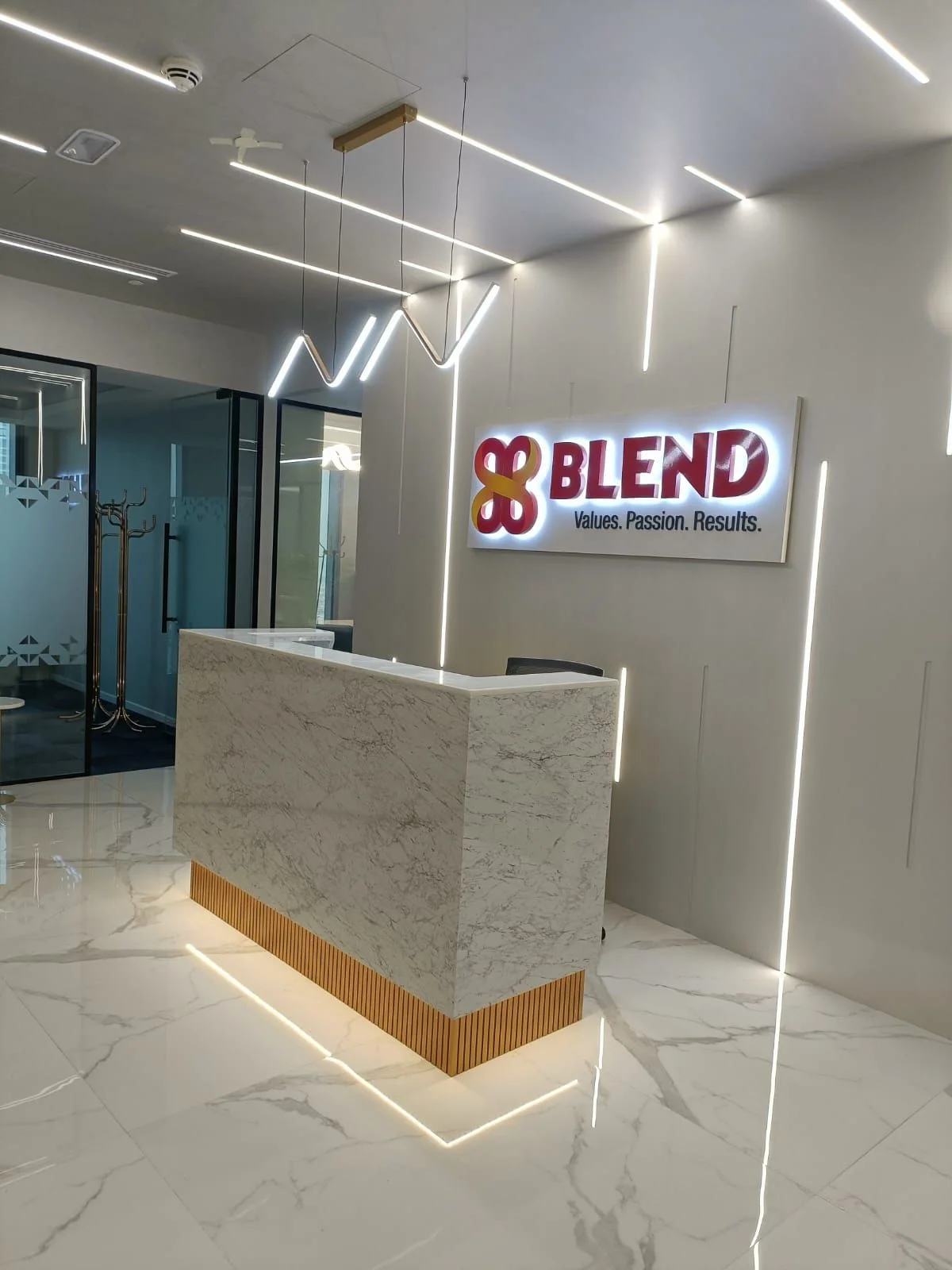 Blend Finance: Stone reception desk with a lit timber base