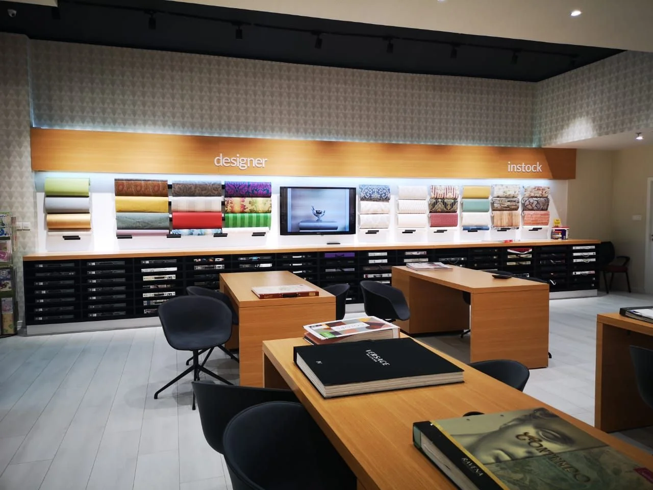 NGC Nafees wallpaper outlet: Wallpaper showroom with timber display walls and sample desks