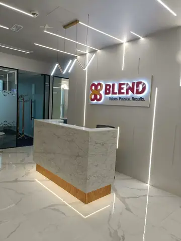 Blend Finance: Stone reception desk with a lit timber base