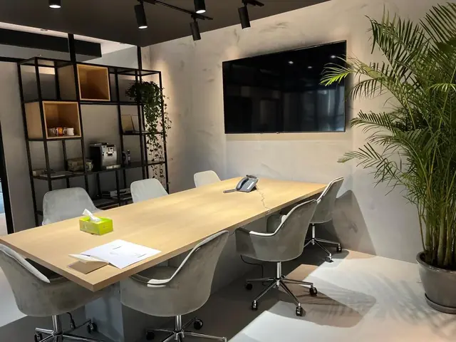 Corporate office: Meeting room with steel shelving and a timber table